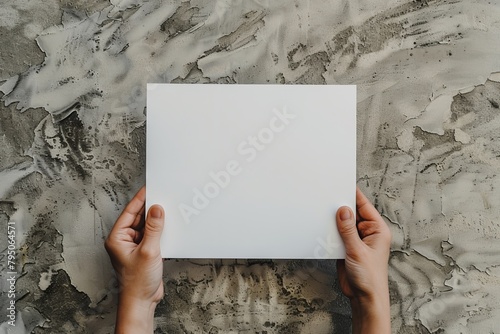 Person holding a blank white paper photo