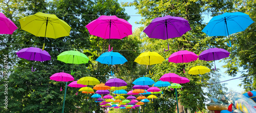 An alley in the city park. An alley with colorful umbrellas