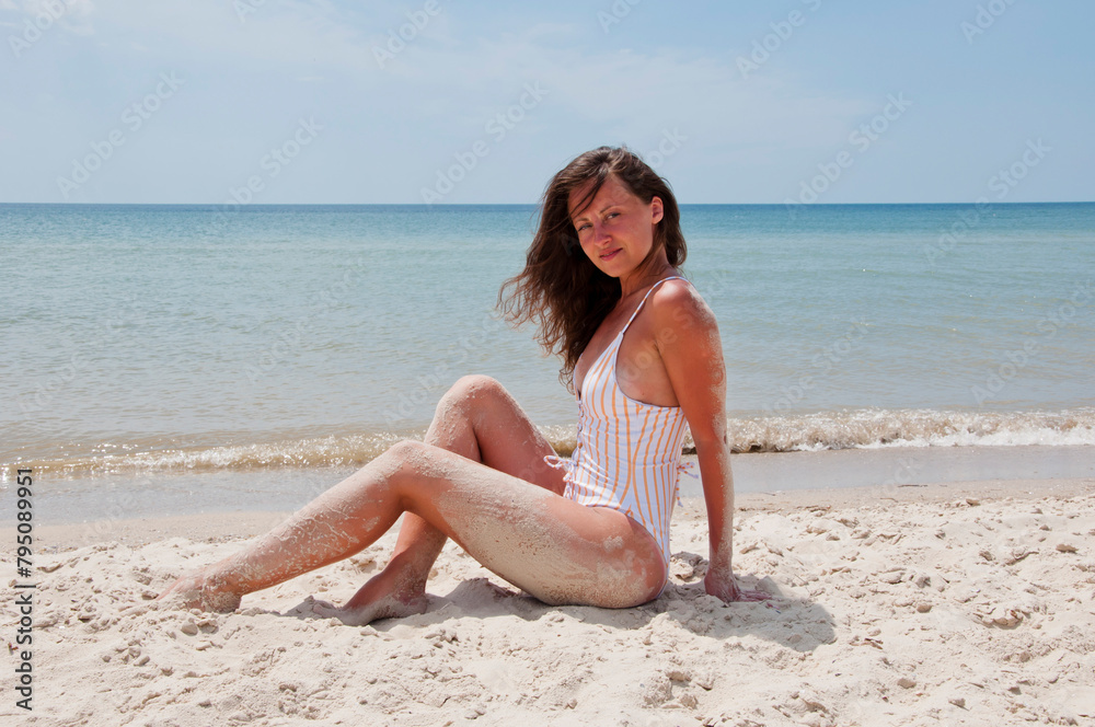 Beach vacation of sand girl. Sea and sand. Woman on summer vacation at beach. Summer vacation of woman in swimsuit. Sexy woman at sea sandy beach. Suntan at summer beach. Exotic place Beach vacation of sand girl. Sea and sand. Woman on summer vacation at beach. Summer vacation of woman in swimsuit. Sexy woman at sea sandy beach. Suntan at summer beach. Exotic place
