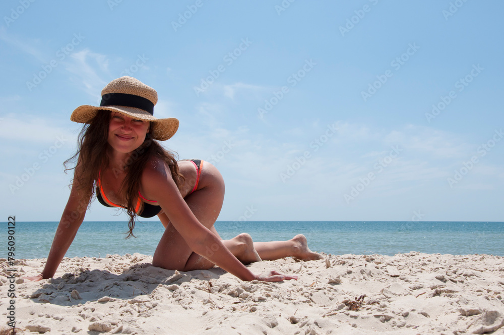 Summer vacation of woman in straw hat. Sexy woman at sea beach. Suntan at summer beach. Beach vacation girl advertisement. Sea travel resort banner. Woman on summer vacation at beach. Copy space