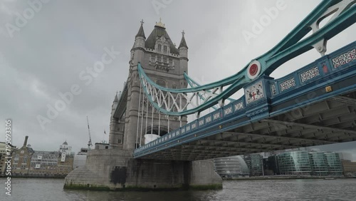 London, United Kingdom - People crossing the Tower Bridge bascule and suspension bridge over River Thames photo