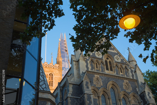 London - The top of Shard tower and tower of Southwark cathedral in evening light.