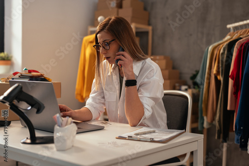 Woman working at the computer in a boutique