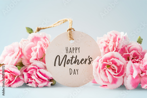 Happy mothers day card with pink flowers on vintage blue background