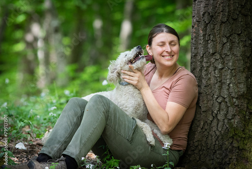 happy woman with her dogs in the forest