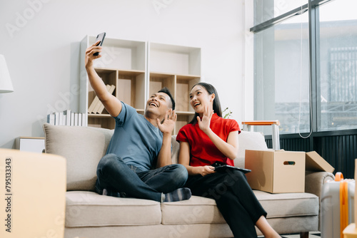 Happy asian young attractive couple man and woman with big boxes moving into a new house, new apartment for couple the new home, Moving house. .