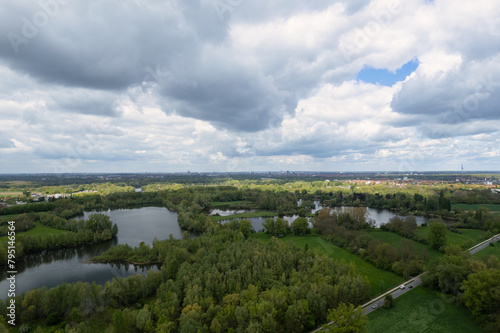 Cloudy sky above a lake with trees and grass, creating a natural landscape Hanover Germany
