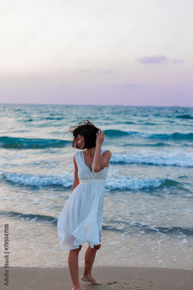 Happy traveler girl in a white summer dress enjoying a tropical paradise beach with turquoise sea. Happy traveler girl in a white summer dress enjoying a tropical paradise beach with turquoise sea.