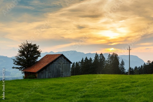 A cottage in the german alps in bavaria during sunset photo