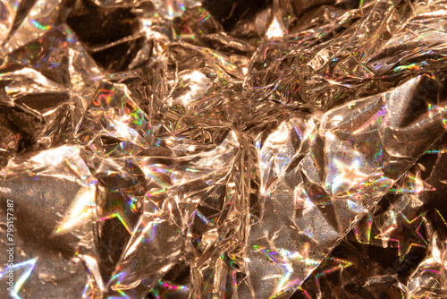 Holographic Crumpled Gold Bronze Paper Material which is Shiny for Background photo