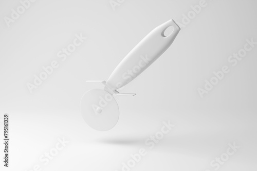 White pizza cutter floating in mid air on white background in monochrome and minimalism. Illustration of the concept of kitchen utensils, takeaway foods and Italian cuisine