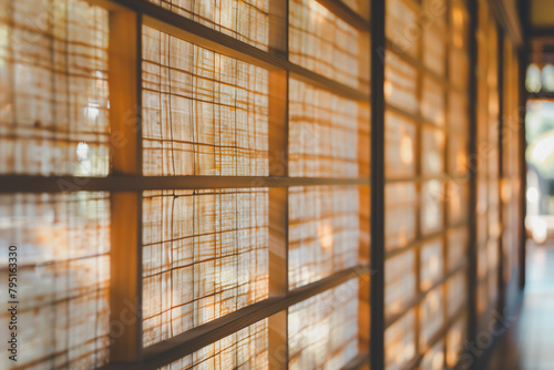 Warm golden sunlight filtering through a traditional rice paper sliding door, embodying tranquility and traditional Japanese architecture. photo