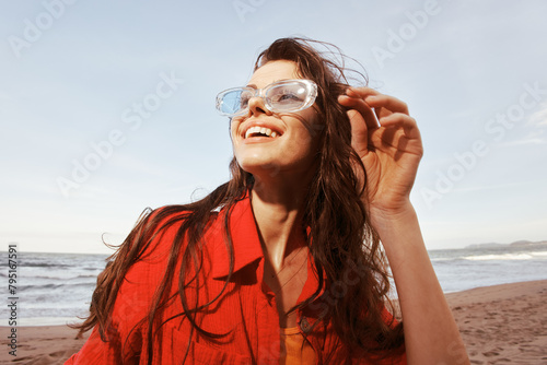 Smiling Woman at the Beach, Embracing Freedom and Nature photo