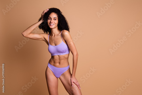 No filter photo of adorable lovely athletic woman wear stylish lingerie empty space isolated on beige color background