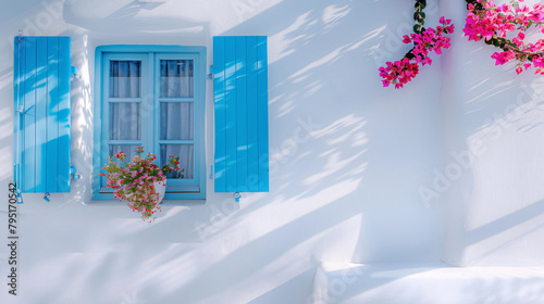 Window with blue shutters and flower. White architectu photo