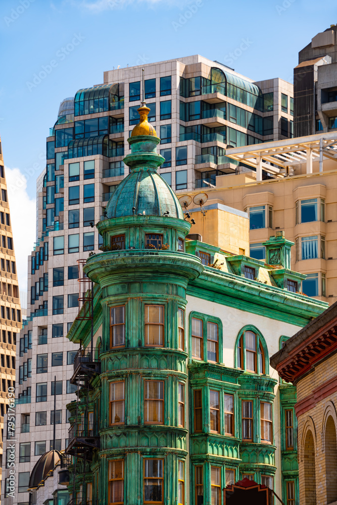 Historic and modern buildings on Columbus Avenue in downtown San Francisco California, Financial District and Chinatown. Colorful Columbus Tower from 1907 with copper-green Flatiron style structure.