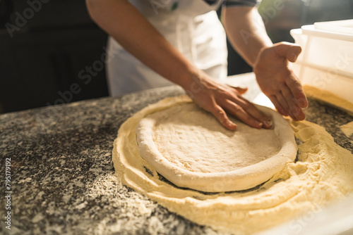 Pizza Process Dough Preparation Close-up shots of the hands kneading and stretching pizza dough on a floured surface, emphasizing the tactile and hands-on nature of the process. High quality photo