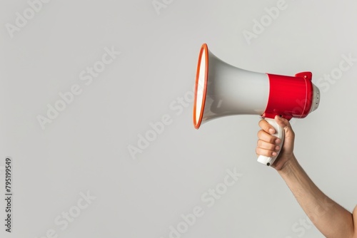 Person Holding a Megaphone Against a Plain White Background in a Neutral Setting