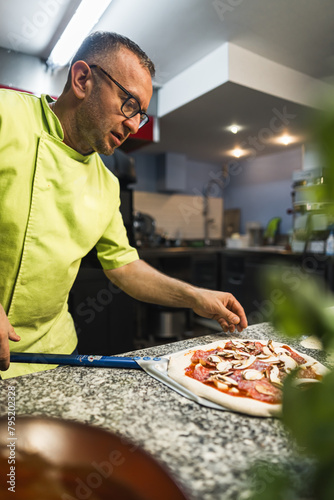 chef preparing pizza to put it in an oven  kitchen concept. High quality photo