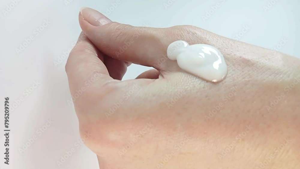Female hands skin care. Woman applying a few drops of moisturizing body lotion to hand skin. Close-up shot Female hands skin care. Woman applying a few drops of moisturizing body lotion to hand skin. Close-up shot