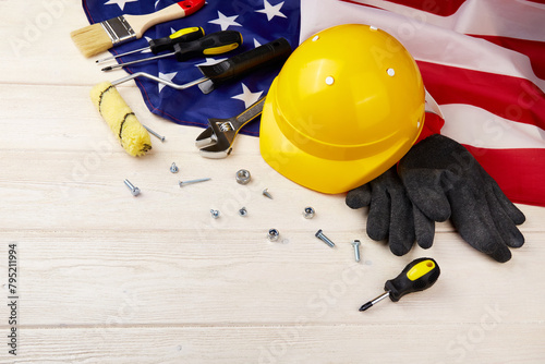 Labor Day, National American Holiday. Mechanic tools and Usa Flag on white wooden background, copy space. 