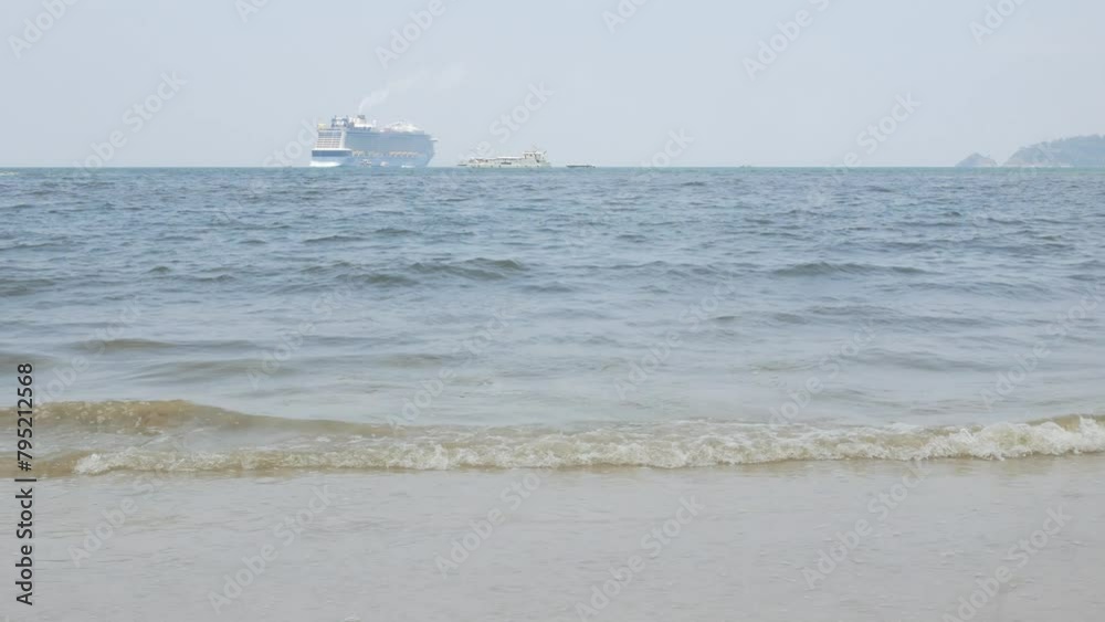 view to the ocean sea with passenger cruise ship tendering in the ocean under sunny sunshine daytime. Tourist cruise ship at tropical sea of Phuket view to the ocean sea with passenger cruise ship tendering in the ocean under sunny sunshine daytime. Tourist cruise ship at tropical sea of Phuket