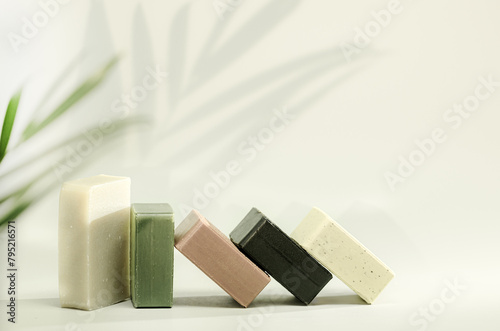 Natural handmade soaps on light green background