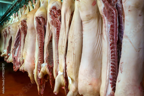 Pork meat in production. Fresh pork carcasses in a meat factory warehouse