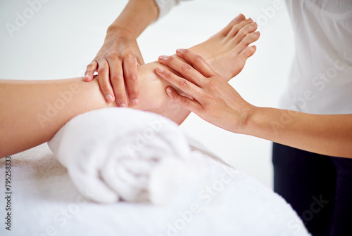 Woman, feet and massage table in spa, therapy and self care for body wellness and resting for tension. Comfortable and resort with client, stress free and healing, calm session and cosmetology