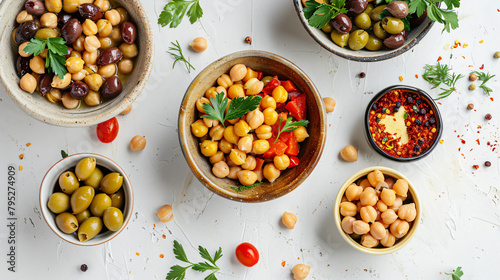 Bowls with chickpeas and olives on light table