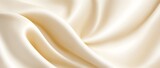 Smooth silk elegance background. Creamy satin fabric with soft texture and flowing waves.