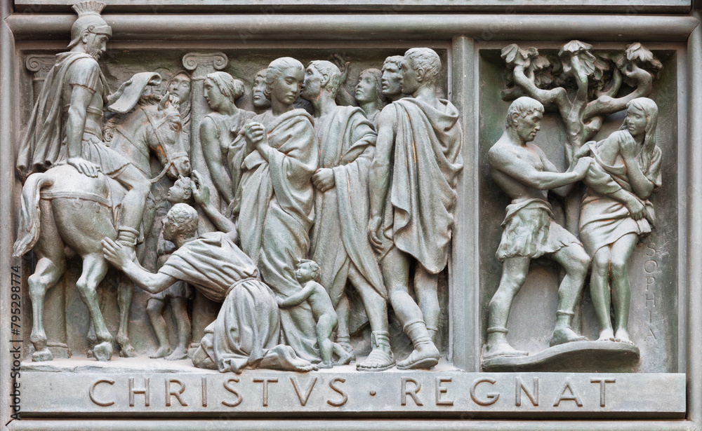 MILAN, ITALY - SEPTEMBER 16, 2024: The relief of Martyrdom of St. Sophia on the bronze gate of Cathedral - Duomo by Arrigo Minerbi (1937 - 1948)