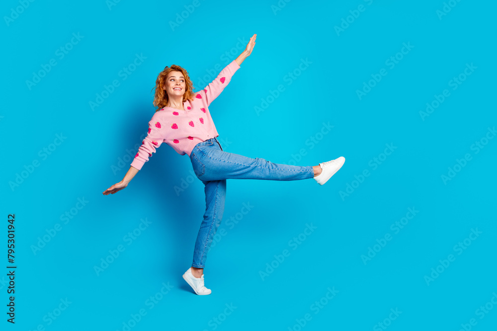 Full length photo of lovely lady playful have fun look empty space dressed stylish pink clothes isolated on blue color background