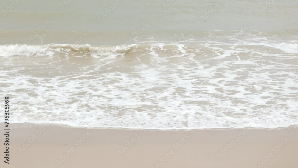 close up to Sea waves rolling over the fine sand beach, waves break on white sand beach with beautiful foam, tropical summer vacation holiday nature background close up to Sea waves rolling over the fine sand beach, waves break on white sand beach with beautiful foam, tropical summer vacation holiday nature background