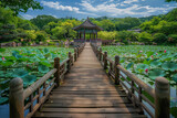 A wooden bridge in a lotus pond, with a Chinese pavilion in the background 