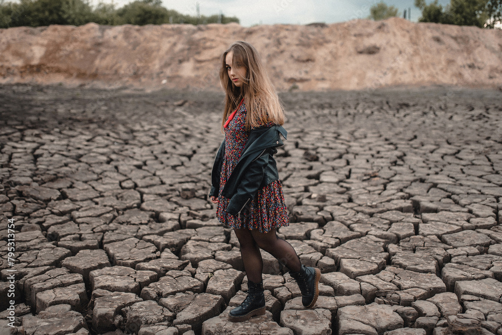 a beautiful pretty young girl in a skirt and jeans smiles at the camera at a photo shoot. Model in beautiful clothes in an unusual location in nature, Women's fashion a beautiful pretty young girl in a skirt and jeans smiles at the camera at a photo shoot. Model in beautiful clothes in an unusual location in nature, Women's fashion