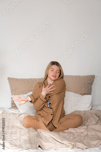 Woman stretching in pajamas with smartwatch