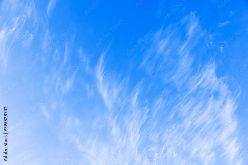 White clouds in blue sky on a windy day, natural background texture White clouds in blue sky on a windy day, natural background texture