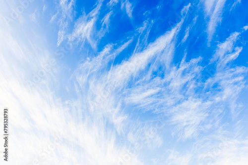 White cirrus clouds are in blue sky, natural background photo texture