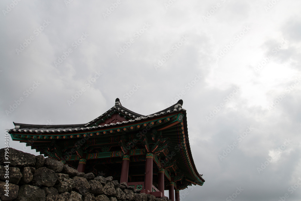 View of the traditional Korean pavilion against the cloudy sky View of the traditional Korean pavilion against the cloudy sky