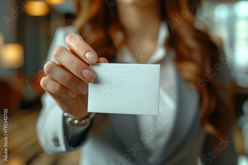 A sharp image of a business card held securely in the manicured hands of a businesswoman, potential for branding photo