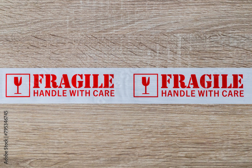 Fragile packing tape on wooden background