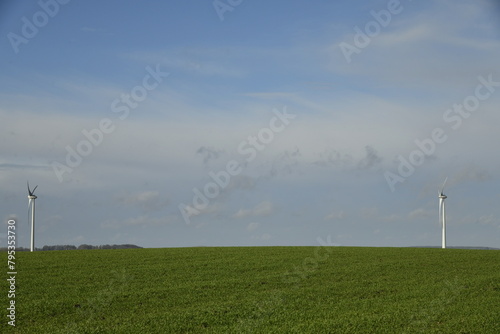 Deux générateurs sous un ciel changeant dans un paysage rural à Ghislenghien photo