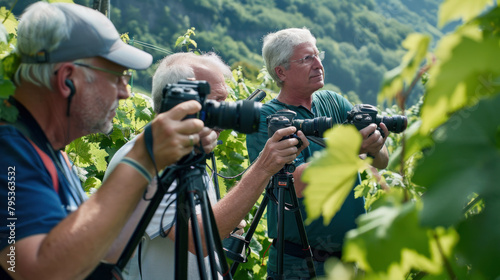Group of wine journalists, photographers and video makers, filming on a vineyard photo