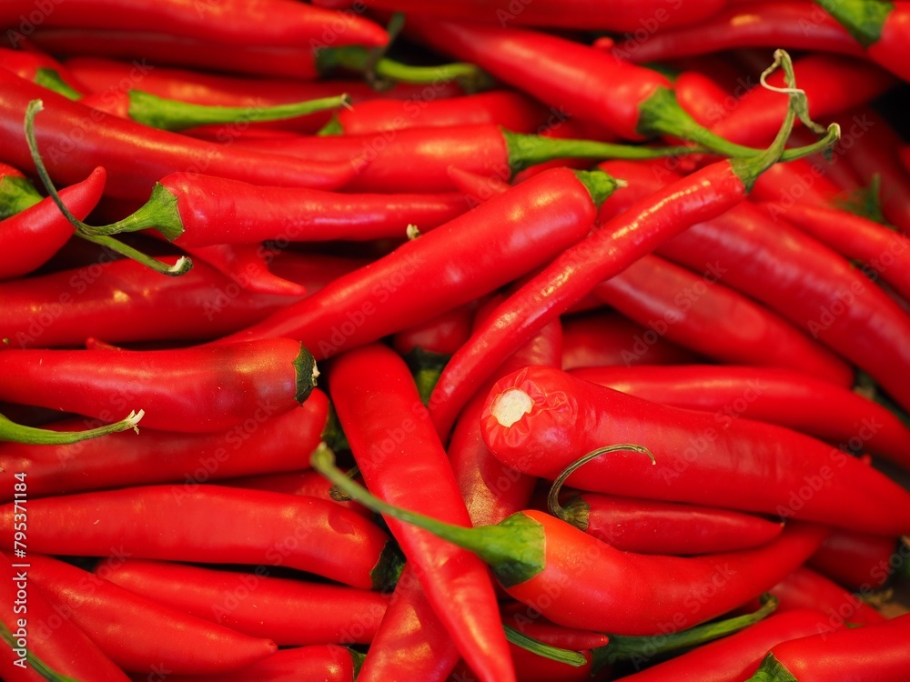 The fiery taste of chili peppers is often balanced with sweet or tangy ingredients in various culinary traditions.

