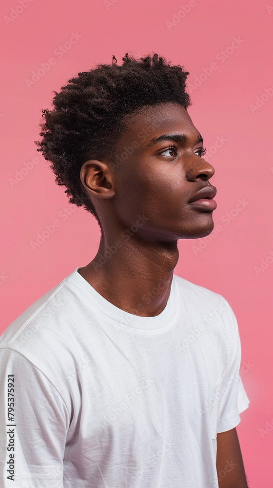 A young man in a white T-shirt on a plain background A young man in a white T-shirt on a plain background