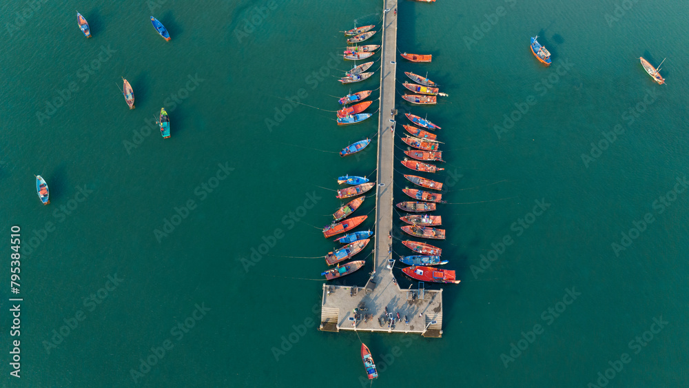 Aerial view of Bridge with long tail boats and beautiful crystal clear water in summer.
