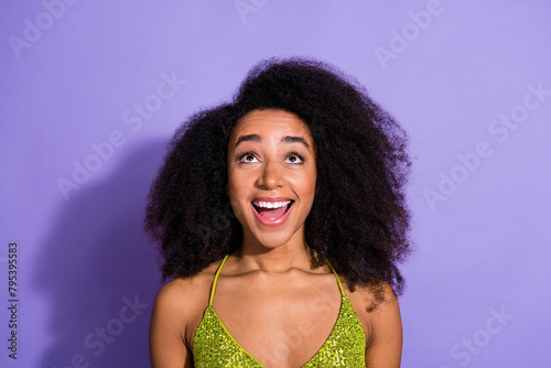 Photo portrait of gorgeous young girl look up empty space wear trendy green sequins outfit isolated on purple color background