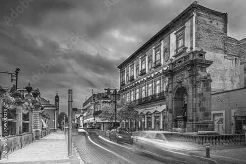 Panoramic of a main street at dusk and with the threat of a storm.