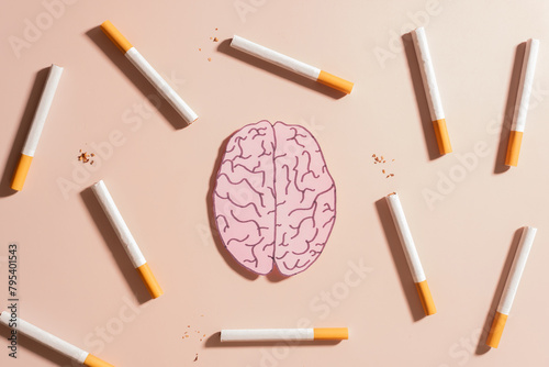 Smoking harms brain health. Tobacco or cigarettes with human brain organ symbol on brown background. Smoking increase risk for brain conditions, such as dementia, and stroke. World no tobacco day.